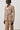 Person wearing a beige suit with a white background