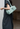 Person holding a light green handbag against a neutral background