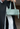 Person holding a light green handbag with a blurred background